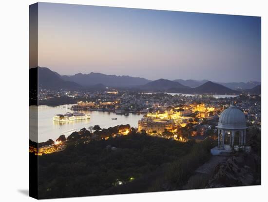 View of City Palace and Lake Palace Hotel at Sunset, Udaipur, Rajasthan, India, Asia-Ian Trower-Stretched Canvas