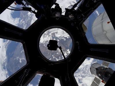 https://imgc.allpostersimages.com/img/posters/view-of-earth-through-the-cupola-on-the-international-space-station_u-L-PJ285A0.jpg?artPerspective=n