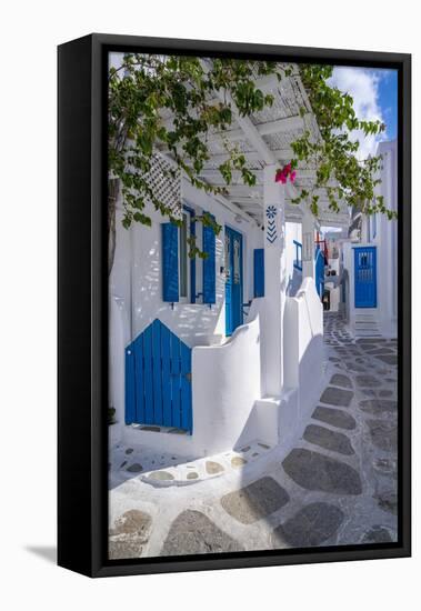 View of girl walking through whitewashed narrow street, Mykonos Town-Frank Fell-Framed Stretched Canvas