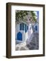 View of girl walking through whitewashed narrow street, Mykonos Town-Frank Fell-Framed Photographic Print