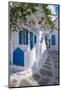 View of girl walking through whitewashed narrow street, Mykonos Town-Frank Fell-Mounted Photographic Print