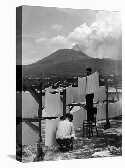 View of Mount Vesuvius from the Town of Torre Annunciata with Men Tending to Drying Pasta-Alfred Eisenstaedt-Stretched Canvas