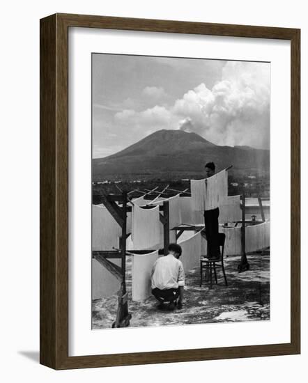 View of Mount Vesuvius from the Town of Torre Annunciata with Men Tending to Drying Pasta-Alfred Eisenstaedt-Framed Photographic Print