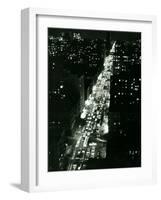 View of New York Illuminated at Night, Traffic Stretches for Miles as Cars Pour into the City-null-Framed Photographic Print