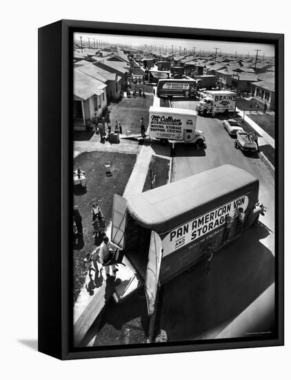 View of Newly Built Houses Jammed Side by Side, Divided by a Street Clogged with Moving Vans-J^ R^ Eyerman-Framed Stretched Canvas