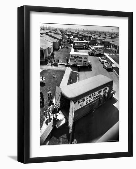 View of Newly Built Houses Jammed Side by Side, Divided by a Street Clogged with Moving Vans-J^ R^ Eyerman-Framed Photographic Print