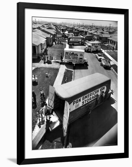 View of Newly Built Houses Jammed Side by Side, Divided by a Street Clogged with Moving Vans-J^ R^ Eyerman-Framed Photographic Print