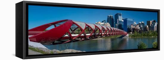 View of Peace Bridge with skylines in the background, Bow River, Calgary, Alberta, Canada-null-Framed Stretched Canvas