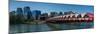 View of Peace Bridge with skylines in the background, Bow River, Calgary, Alberta, Canada-null-Mounted Photographic Print