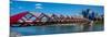 View of Peace Bridge with skylines in the background, Bow River, Calgary, Alberta, Canada-null-Mounted Photographic Print