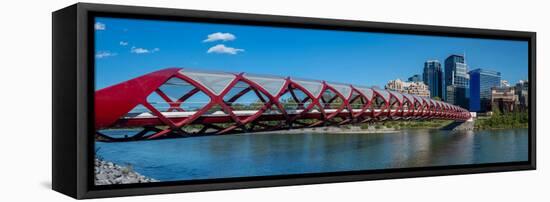 View of Peace Bridge with skylines in the background, Bow River, Calgary, Alberta, Canada-null-Framed Stretched Canvas