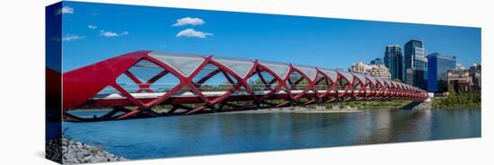 View of Peace Bridge with skylines in the background, Bow River, Calgary, Alberta, Canada-null-Stretched Canvas