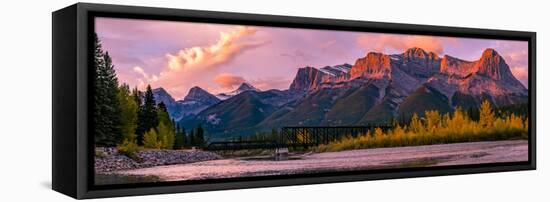 View of rail bridge over river and Three Sisters Mountain Canmore, Alberta, Canada-Panoramic Images-Framed Stretched Canvas