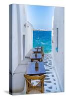View of sea and restaurant tables in Mykonos Town, Mykonos, Cyclades Islands, Aegean Sea-Frank Fell-Stretched Canvas