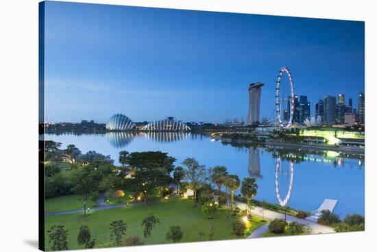 View of Singapore Flyer, Marina Bay Sands Hotel and Gardens by the Bay at dawn, Singapore-Ian Trower-Stretched Canvas