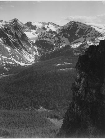 https://imgc.allpostersimages.com/img/posters/view-of-snow-capped-mt-timbered-area-below-in-rocky-mountain-national-park-colorado-1933-1942_u-L-Q1I49K20.jpg?artPerspective=n