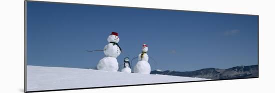 View of Snowmen in Snow Covered Landscape, Waterbury, Vermont, USA-null-Mounted Photographic Print
