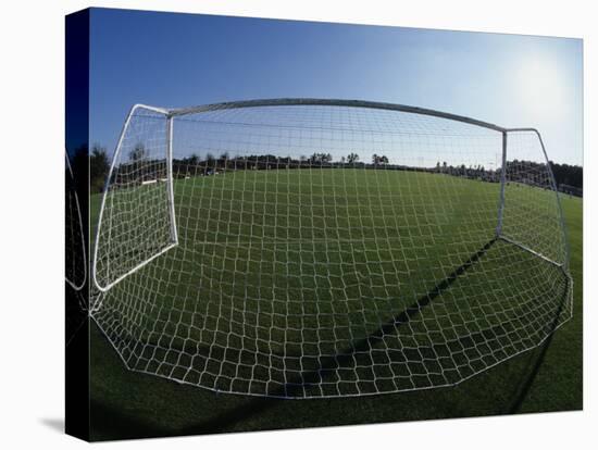 View of Soccer Field Through Goal-Steven Sutton-Stretched Canvas