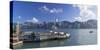 View of Star Ferry Terminal and Hong Kong Island skyline, Hong Kong, China-Ian Trower-Stretched Canvas