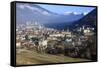 View of the city of Chur surrounded by woods and snowy peaks, district of Plessur, Canton of Graubu-Roberto Moiola-Framed Stretched Canvas