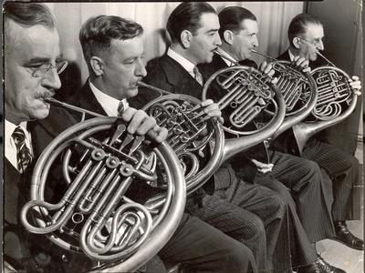 https://imgc.allpostersimages.com/img/posters/view-of-the-french-horn-section-of-the-new-york-philharmonic_u-L-Q1HSR840.jpg?artPerspective=n