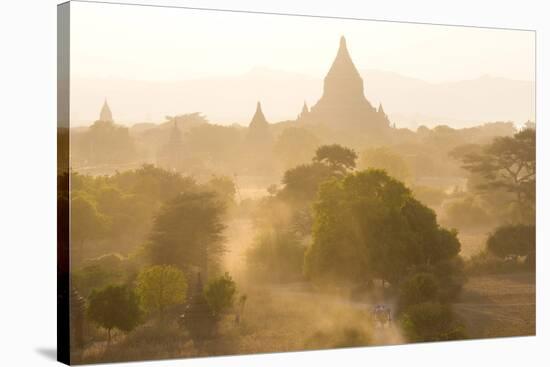 View over the Temples of Bagan Swathed in Dust and Evening Sunlight-Lee Frost-Stretched Canvas