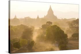 View over the Temples of Bagan Swathed in Dust and Evening Sunlight-Lee Frost-Stretched Canvas