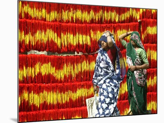 Villagers Walk Past Freshly Dyed Kalawa, a Sacred Orange-Yellow Thread Used in Hindu Rituals-null-Mounted Photographic Print
