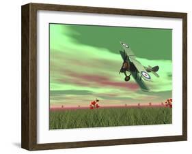 Vintage Biplane Flying Above Green Grass with Flowers by Sunset-null-Framed Art Print