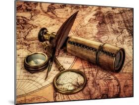 Vintage Magnifying Glass, Compass, Goose Quill Pen And Spyglass Lying On An Old Map-Andrey Armyagov-Mounted Art Print