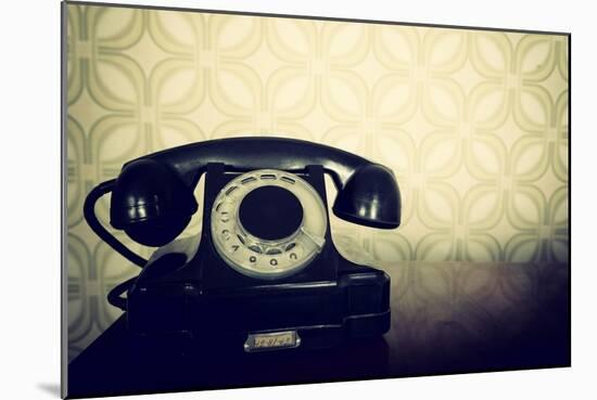 Vintage Old Telephone, Black Retro Phone Is On Wooden Table Over Green Old-Fashioned Wallpaper-khorzhevska-Mounted Art Print