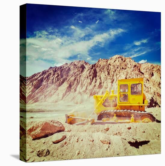 Vintage Retro Effect Filtered Hipster Style Travel Image of Bulldozer Doing Road Construction in Hi-f9photos-Stretched Canvas