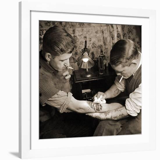 Vintage Shot of a Man Being Tattooed-null-Framed Premium Photographic Print