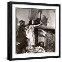 Vivien Leigh Placing Her Oscar on Her Mantelpiece at Home-Peter Stackpole-Framed Photographic Print