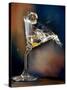 Vodka Martini Spilling from a Bent Martini Glass with Ice Cube-Jeff Sarpa-Stretched Canvas