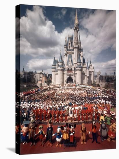 Walt Disney Characters and Park Staff Posing En Masse in Front of Cinderella's Castle-Yale Joel-Stretched Canvas