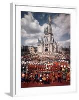 Walt Disney Characters and Park Staff Posing En Masse in Front of Cinderella's Castle-Yale Joel-Framed Photographic Print