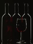 Silhouette of Three Red Wine Bottles and One Red Wine Glass-Walter Cimbal-Photographic Print