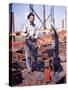 War Worker Holding Red Hot Metal Piece with Tongs at Shipyard-George Strock-Stretched Canvas
