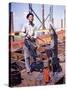 War Worker Holding Red Hot Metal Piece with Tongs at Shipyard-George Strock-Stretched Canvas