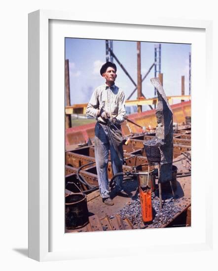 War Worker Holding Red Hot Metal Piece with Tongs at Shipyard-George Strock-Framed Photographic Print
