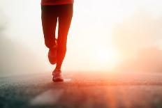 Runner Feet Running on Road Closeup on Shoe. Woman Fitness Sunrise Jog Workout Welness Concept.-warrengoldswain-Photographic Print