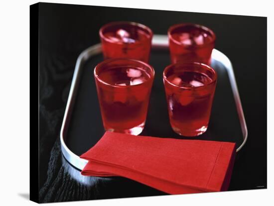 Water and Ice Cubes in Red Glasses on Tray-Michael Paul-Stretched Canvas