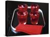 Water and Ice Cubes in Red Glasses on Tray-Michael Paul-Stretched Canvas