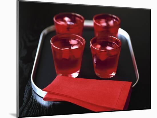 Water and Ice Cubes in Red Glasses on Tray-Michael Paul-Mounted Photographic Print