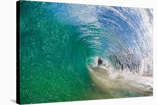 Water shot of a tubing wave off a Hawaiian beach-Mark A Johnson-Stretched Canvas