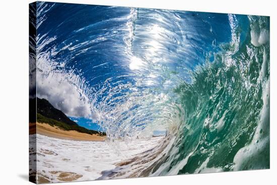 Water shot of a tubing wave off a Hawaiian beach-Mark A Johnson-Stretched Canvas