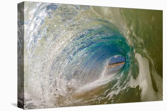 Water shot of a tubing wave off a Hawaiian beach-Mark A Johnson-Stretched Canvas