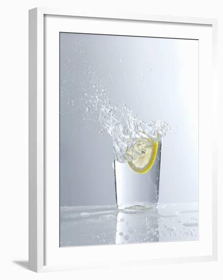 Water Splashing Out of a Glass-Karl Newedel-Framed Photographic Print