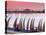 Waterfront Scene at Huanchaco in Peru, Locals Relax Next to Totora Boats Stacked Along the Beach-Andrew Watson-Stretched Canvas